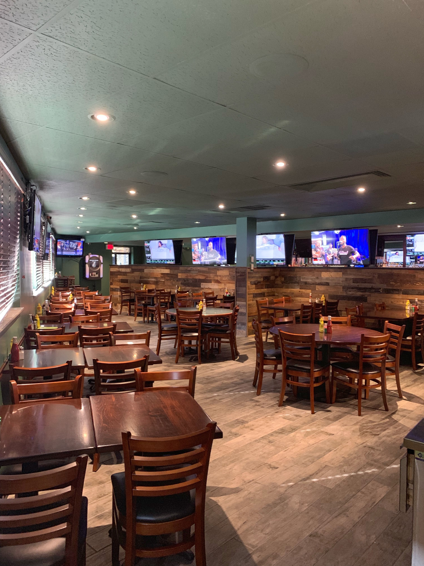 Wall of flatscreen TVs broadcasting live sports