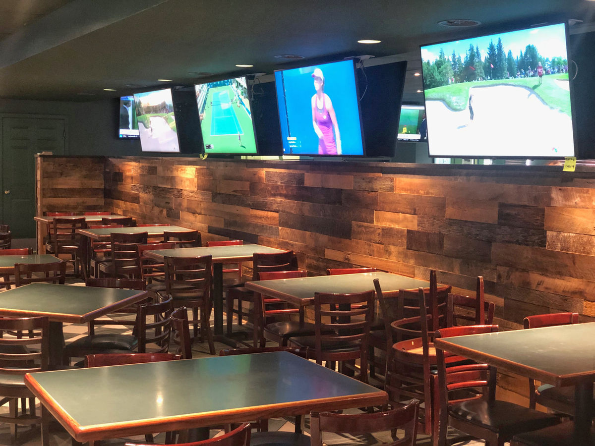 Crowded bar on game day with fans watching hockey