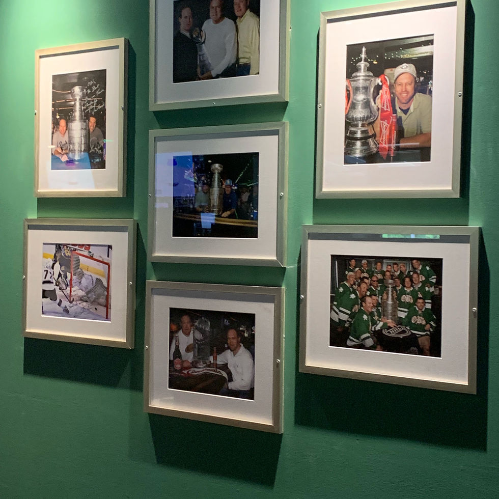 Patrons cheering and toasting pints at the bar